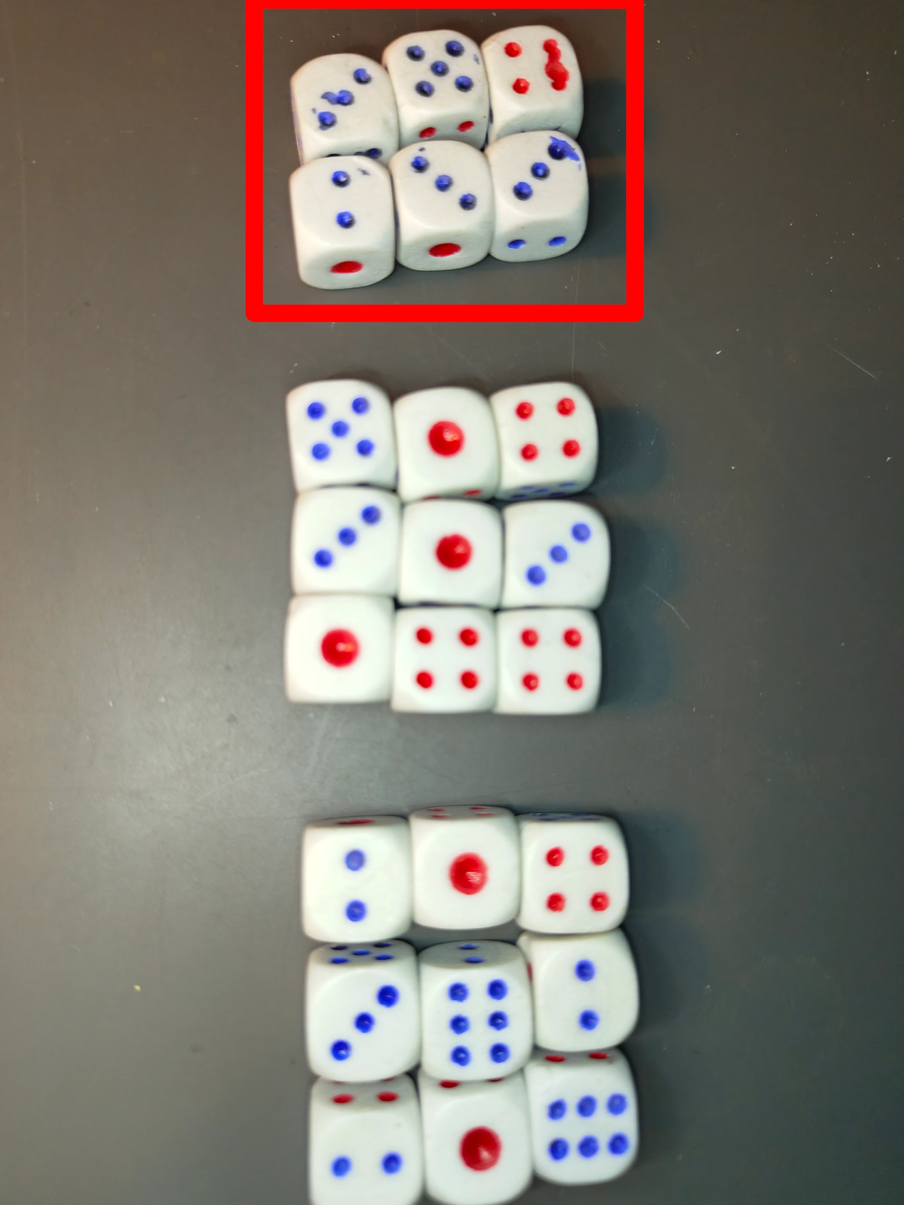 3 groups of dice, one with 6 with paint defects and 2 groups of 9 clean ones